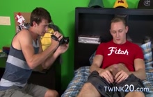 Identical twin brothers jerking off together on the bed